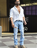 Shahid Kapoor in a white open-button shirt and distressed jeans.jpg