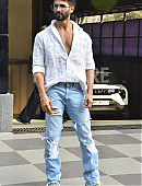 Shahid Kapoor in a white open-button shirt and distressed jeans.jpg