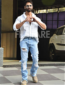 Shahid Kapoor in a white open-button shirt and distressed jeans.jpg