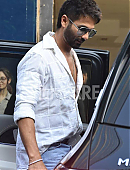 Shahid Kapoor in a white open-button shirt and distressed jeans.jpg