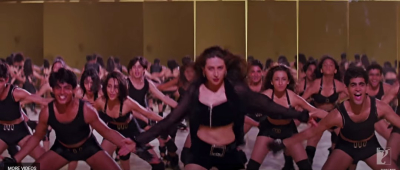 In song LE GAYI as background dancer just behind Karishma Kapoor. 
